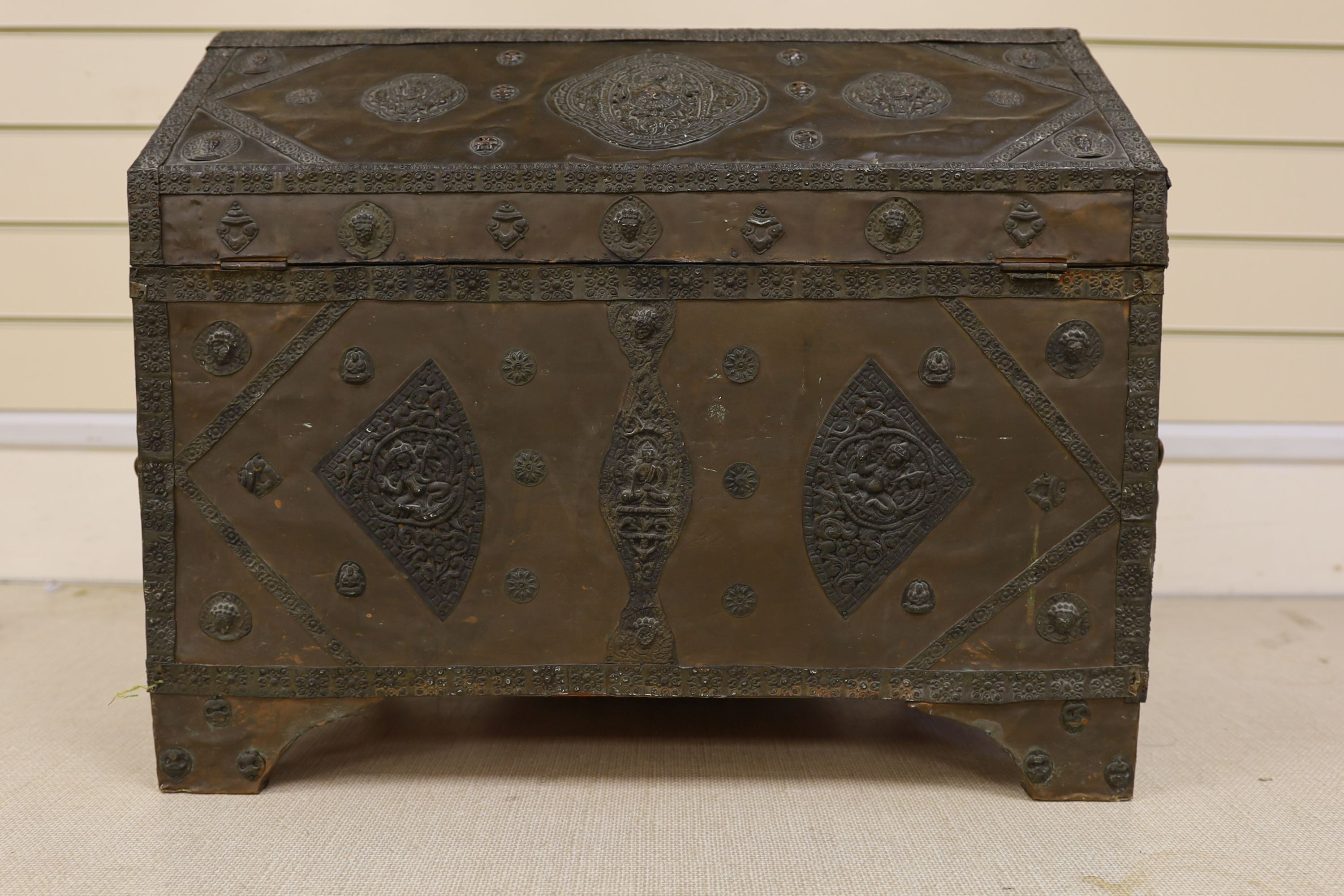 A Tibetan copper repousse-work casket, 20th century, 65cm wide, 49.5cm